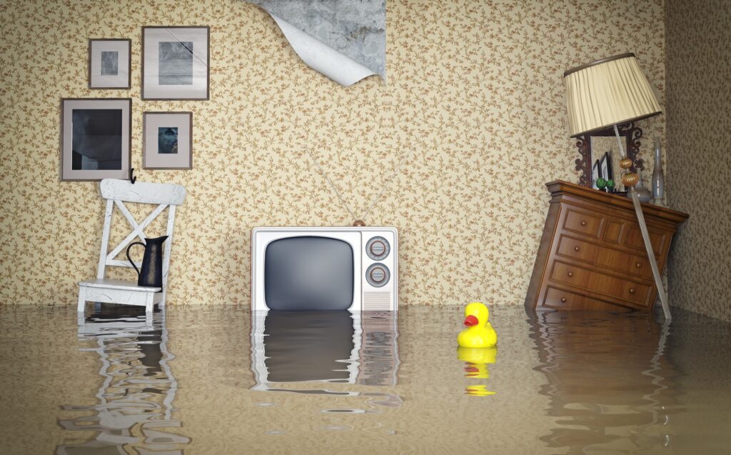 room of a home flooded with tv dresser sitting chair wallpaper torn and rubber duck
