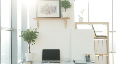 Front view picture of studio workplace with blank notebook, laptop Side view picture of studio workplace with blank notebook, laptop. Designer comfortable work table, home office