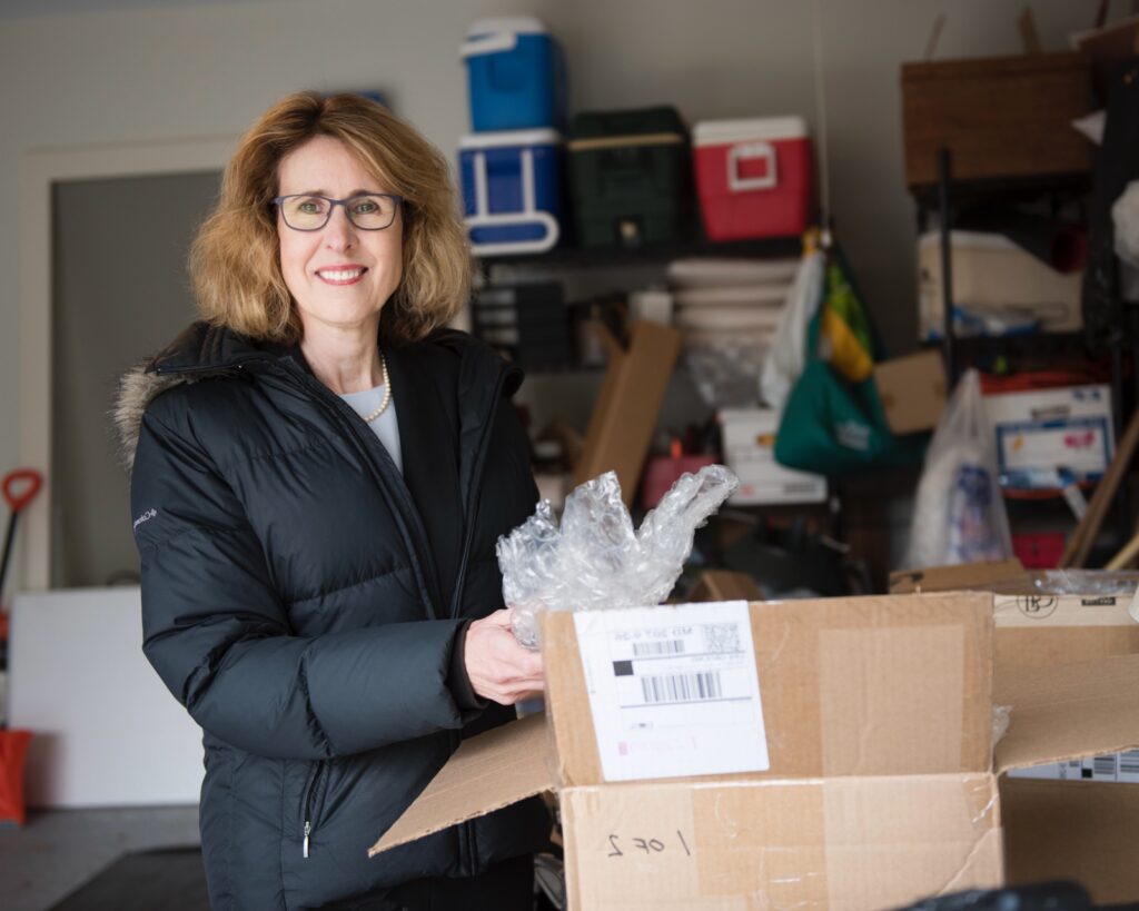 Potomac Concierge employee unpacking box in garage